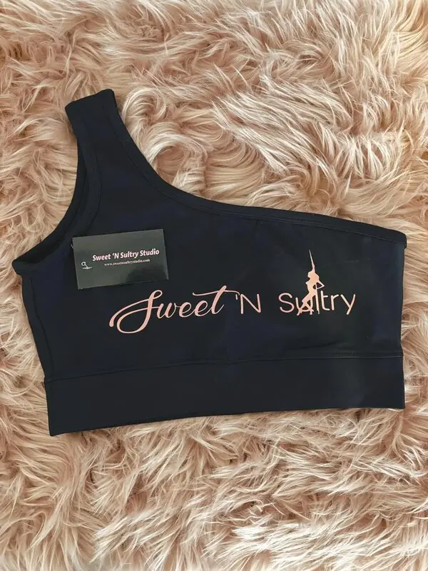 Black one-shoulder SNS bra top with pink script logo