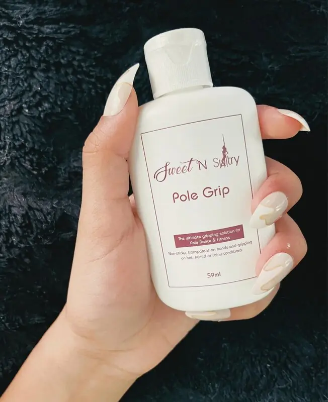 Hand holding a white bottle of SNS pole grip